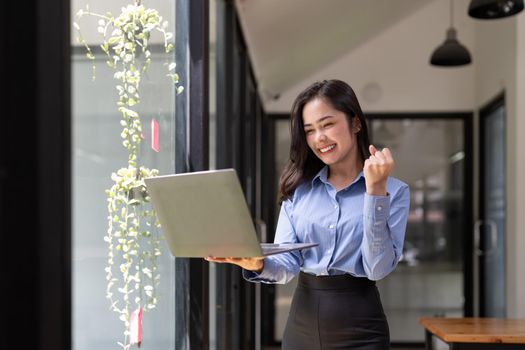 Beautiful asian young woman excited and glad of success with laptop computer, career freelance business concept