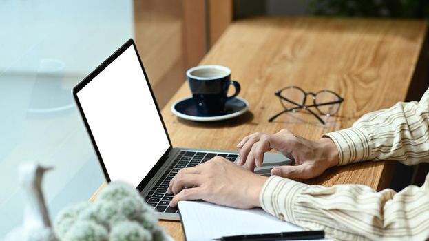 Businessman searching information on laptop computer.