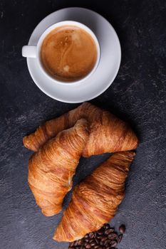 Top view of traditional croissants with hot coffee. Golden croissants.