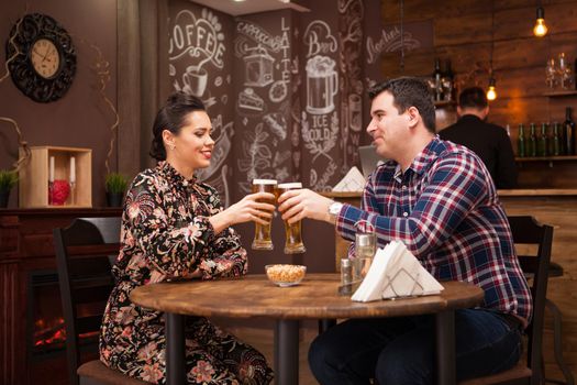 Couple in love on date drinking beer and having a good time. Beautiful couple.