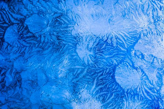 Abstract frosty pattern on glass, background texture on the window.