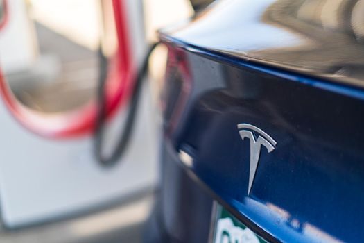 Baker, California, USA-October 12, 2021 - Tesla supercharging station during the day.