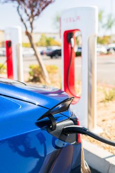 Hesperia, California, USA-October 12, 2021 - Tesla supercharging station during the day.