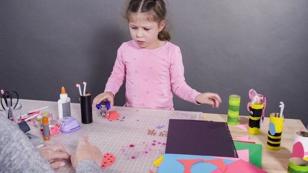 Kids papercraft. Making paper bugs out of the empty toilet paper rolls and construction paper.