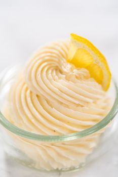 Swirl lemon buttercream frosting in a small glass bowl.