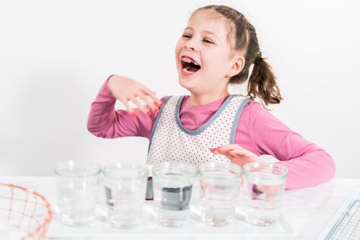 Easter egg coloring. Mixing food coloring with water and a dash of white vinegar to dye Easter eggs.