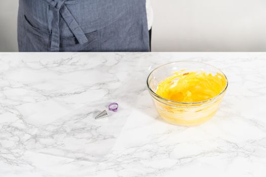 Mixing food coloring into the meringue to bake meringue cookies.