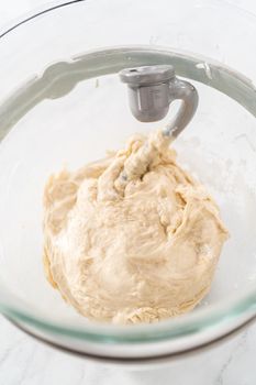 Mixing bread dough in a stand-alone kitchen mixer to bake patriotic cinnamon twists.