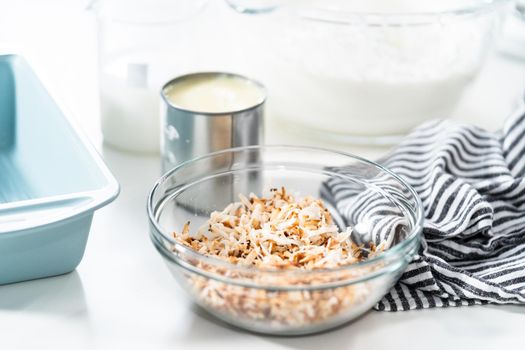 Preparing homemade coconut ice cream with roasted coconut flakes.