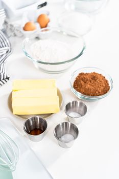 Ingredients in mixing bowls on the counter to bake chocolate cookies.