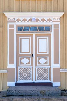 Image of The detail of colorful decorated historic wooden entrance door of old house in Sweden