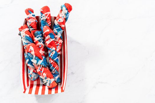 Patriotic cinnamon twists drizzled with a white glaze and decorated with star sprinkles.