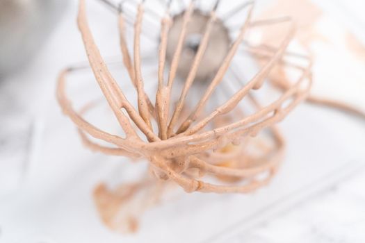 Mixing ingredients in a standing kitchen mixer to make homemade chocolate ice cream.