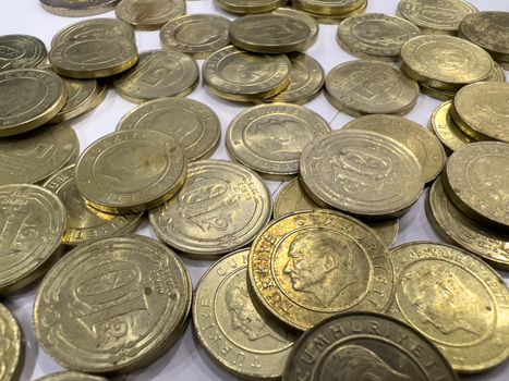 Turkish coins of 10 kurus and 5 kurus standing in a pile on a white background