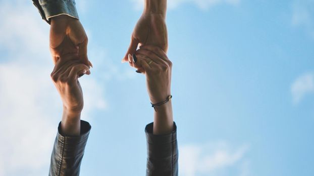 young male couple holding hands standing on their way together.