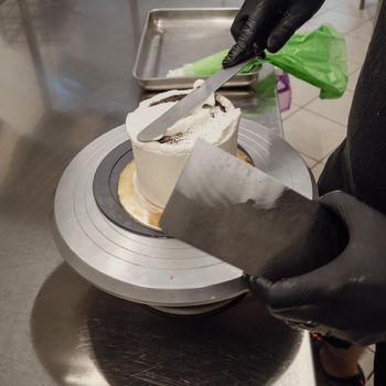 chef at work preparing a drip cake