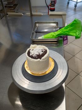 chef at work preparing a drip cake