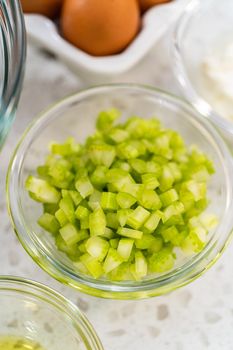 Measured ingredients in glass mixing bowls to make potato salad.