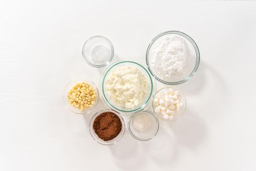 Flat lay. Measured ingredients in glass mixing bowls to make homemade hot chocolate mix.