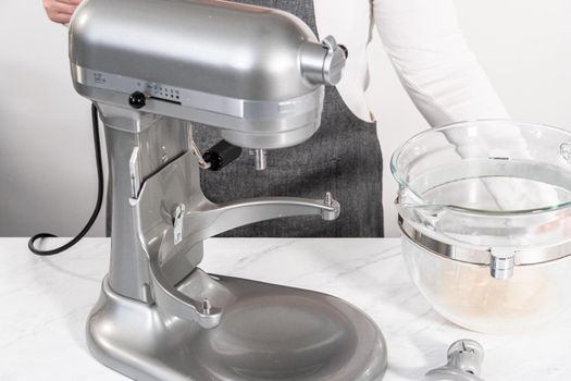 Mixing bread dough in a stand-alone kitchen mixer to bake patriotic cinnamon twists.