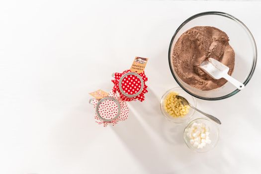 Flat lay. Making homemade hot chocolate mix in drinking mason jar for Christmas food gift.