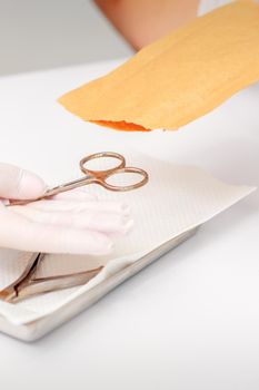 Master of manicure sterilizing manicure scissors. Disinfection of manicure tools