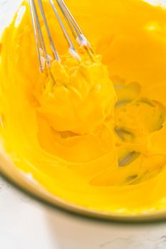 Mixing food coloring into the meringue to bake meringue cookies.