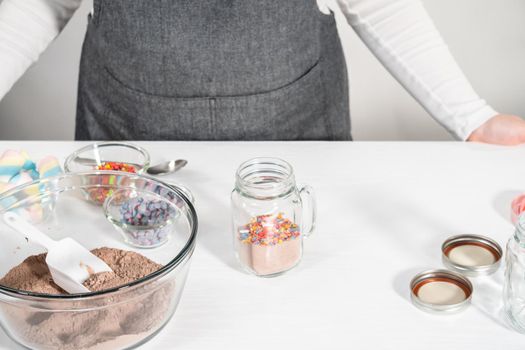 Making unicorn hot chocolate mix in drinking mason jar as a food gift.