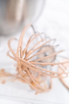 Mixing ingredients in a standing kitchen mixer to make homemade chocolate ice cream.