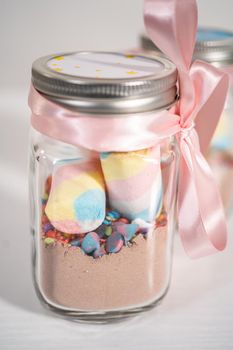 Making unicorn hot chocolate mix in drinking mason jar as a food gift.