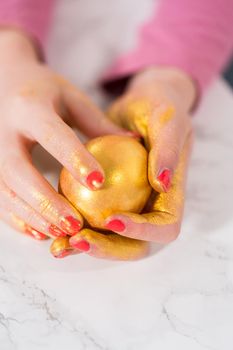 Easter egg coloring. Painting Easter eggs with gold luster.