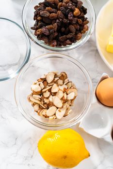 Measured ingredients in glass mixing bowls to bake mini Easter bread kulich.