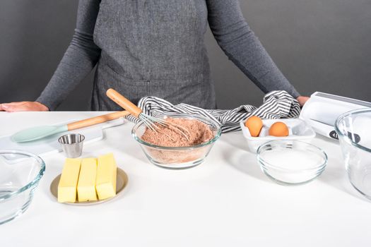 Ingredients in mixing bowls on the counter to bake chocolate cookies.