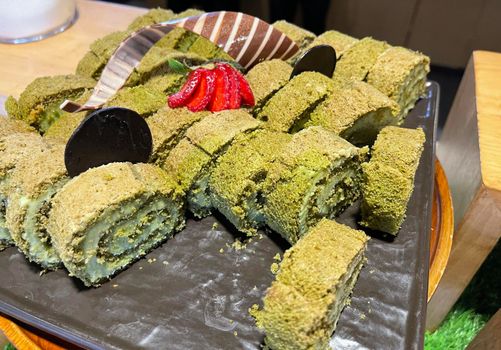 Sponge roll cake with strawberry and chocolate slice and pistachio, food photography concept in fancy restaurant