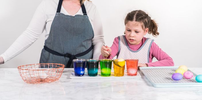 Easter egg coloring. Dye white organic eggs in different colors for Easter.