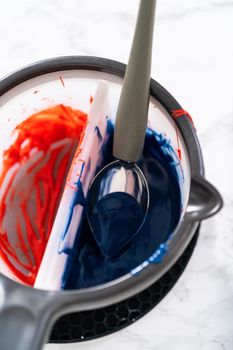 Melting chocolate chips in a candy melting pot to make chocolate stars for patriotic lemon cupcakes.