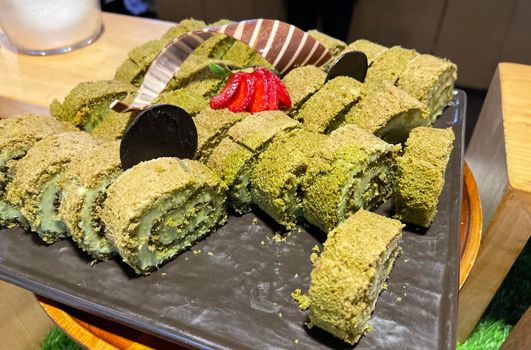 Sponge roll cake with strawberry and chocolate slice and pistachio, food photography concept in fancy restaurant