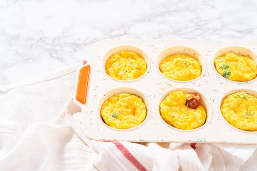 Cooling fresh out of the oven bacon and cheese egg muffin.