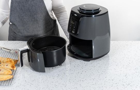 Frying sweet cherry empanadas in the air fryer.