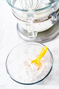 Mixing ingredients in kitchen electric mixer to bake meringue cookies.