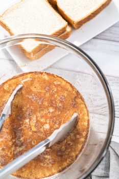 French toast batter in a large glass mixing bowl.