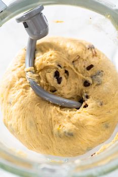 Mixing ingredients in kitchen mixer to bake mini Easter bread kulich.