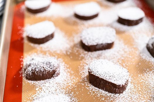 Unbaked chocolate cookies on a baking sheet.