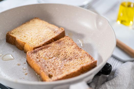 Frying french toast in a nonstick frying pan.