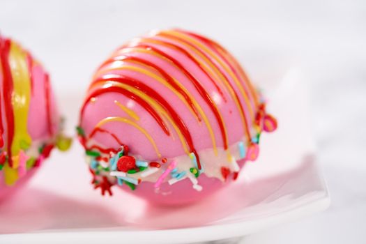 Christmas hot chocolate bombs on a white plate.