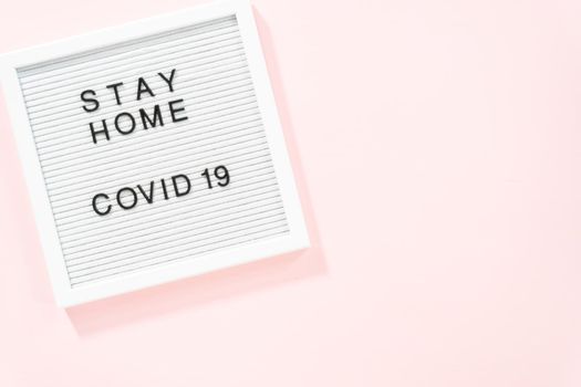 STAY HOME and COVID-19 sign on message board.