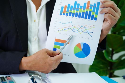 Business woman working and analysis with statistic graph in office.