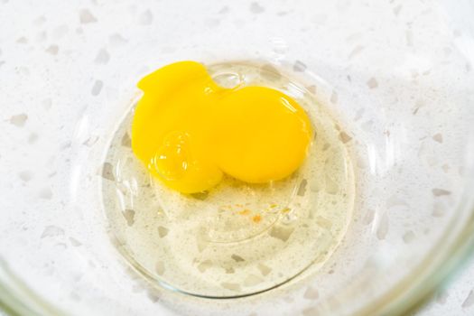 Whisking an egg to make an egg wash for sweet cherry empanadas.