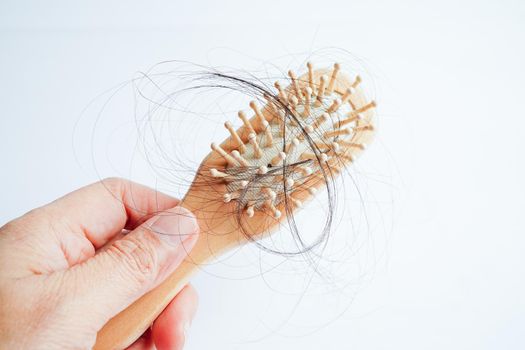  Hair loss fall with comb brush isolated on white background.