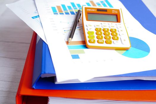 Calculator on chart and graph spreadsheet paper. Finance development, Banking Account, Statistics, Investment Analytic research data economy, Stock exchange trading, Business company concept.